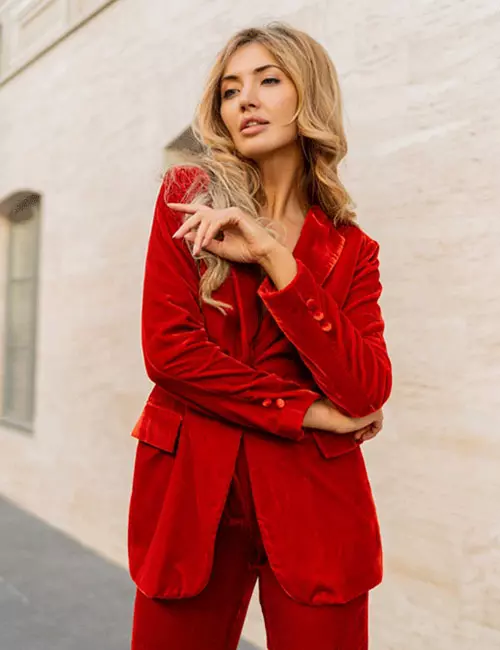 A-woman-wearing-a-vibrant-red-velvet-suit-for-a-formal-wedding