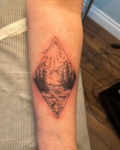 Geometric-mountain-tattoo-with-trees