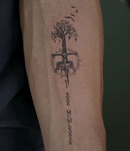 Sword-and-Crown-Tattoo-on-Forearm